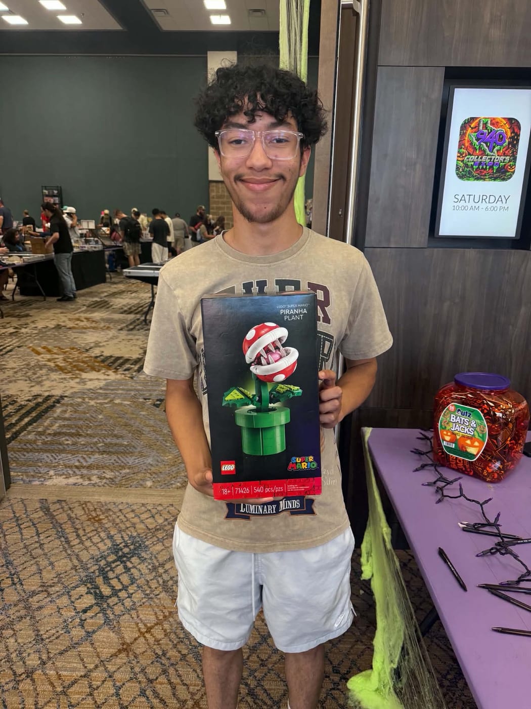 An attendee holding the LEGO Super Mario Piranha Plant set he won at the show